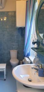 a bathroom with a white sink and a toilet at Belfiore house in Valverde +15 photos