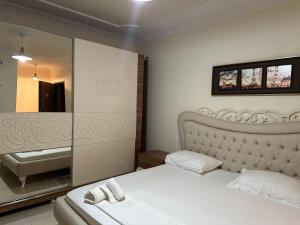 a bedroom with a bed and a sink and a mirror at Oasis Beach Residence in Vlorë