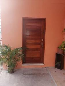a wooden door in the side of a building at La Casa Naranja en Holbox in Holbox Island