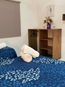a room with a bed with a towel on it at La Casa Naranja en Holbox in Holbox Island