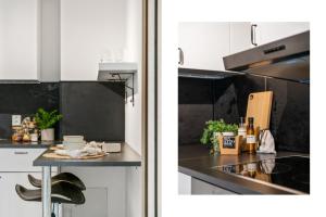 a kitchen with white cabinets and a counter with a table at Perfect getaway 7 min to centrum in Bergen