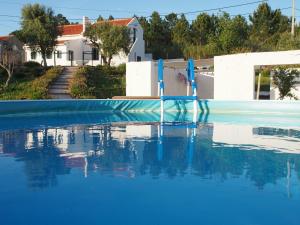 a swimming pool with a blue water slide at Casal Regina in Sesimbra