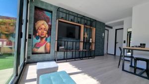a living room with a large painting on the wall at La Terraza del Àtico con parking incluido in Vigo