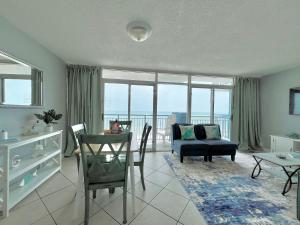 a living room with a couch and a table at Oceanfront 2BR King Suite Atlantica Resort in Myrtle Beach