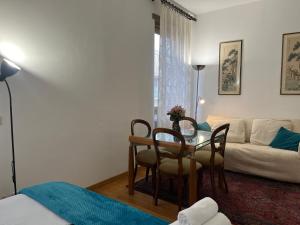 a living room with a table and a couch at Piazza del Popolo - Attico in Rome +20 photos