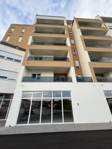 an apartment building with large windows at Studio apartman M in Posušje +5 photos