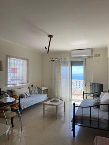 a living room with a couch and a table at Orsalia's Apartment in Neapoli Voion