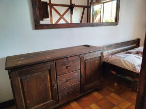 a bedroom with a wooden dresser and a mirror at Pokoje Gościnne Skalnik in Kostrzyn nad Odrą