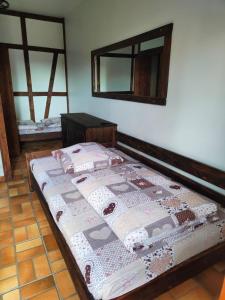 a bedroom with a bed with a quilt on it at Pokoje Gościnne Skalnik in Kostrzyn nad Odrą