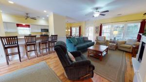 a living room filled with furniture and a kitchen at 1308 Lovell Avenue by Tybee Vacation Rentals in Tybee Island +113 photos