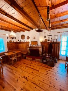 a living room with a table and a fireplace at 9mouses Chasiotis Guest House in Ampelakia