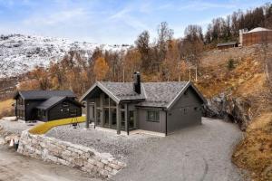 an aerial view of a house with a stone wall at Hytte med fjellutsikt til nydelig natur in Sogndal