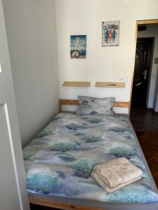 a bed in a room with a blue blanket at Lux Apartment Vivo Mall in Baia Mare