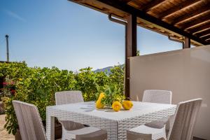 a white table with fruit on top of it at Casa Vacanza Saraceno in Castellammare del Golfo