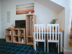 a dining room with a table and two chairs at Nairn View Guest House in Nairn