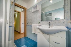 a bathroom with a sink and a mirror at Casa Vacanza Saraceno in Castellammare del Golfo