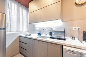 a kitchen with a sink and a microwave at Salve Rooms(tabidze) in Tbilisi City