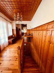 a room with wooden walls and a wooden floor at 9mouses Chasiotis Guest House in Ampelakia
