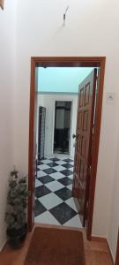 a hallway with a door and a checkered floor at Zawaiaroom in Lagos