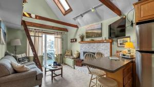 a kitchen and living room with a couch and a fireplace at 131 #5 North Shore Boulevard East Sandwich -- Waters Edge #5 in East Sandwich