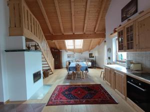 a kitchen with a staircase and a living room at Masches in Funes