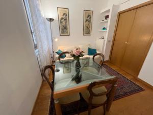 a dining room table with a vase of flowers on it at Piazza del Popolo - Attico in Rome