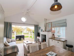 a living room with a couch and a table at Sea Breeze in Filey