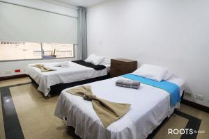 a room with two beds and a window at Apartamento privado en Medellin MAG301 in Medellín
