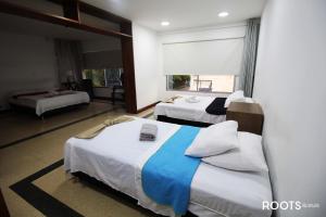 a hotel room with two beds and a window at Apartamento privado en Medellin MAG301 in Medellín