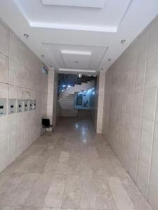 a room with a hallway with a tile wall at شقق ريان المفروشه in Riyadh
