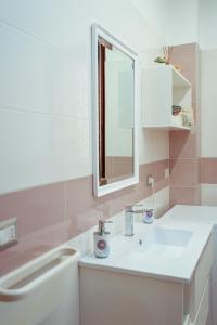 a bathroom with a sink and a mirror at Massanè Casa Vacanza in Ginosa