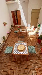 a patio with a table and chairs on a floor at Nicolas Beach in Palaiochora