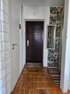 a hallway with a wooden door in a room at Studio Gdańsk Wrzeszcz in Gdańsk