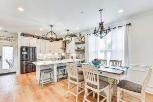 a kitchen with white cabinets and a table and chairs at Charming Bluffton Home with Yard about 3 Mi to Beaches! in Bluffton