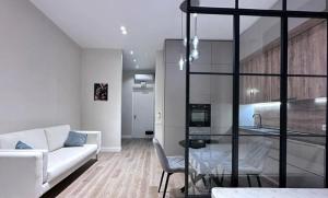 a living room with a white couch and a table at Pearbow Apartment 232 in Hallignicourt