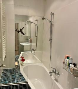 a bathroom with a tub and a glass shower at Feel at home - Self Check In in Vienna