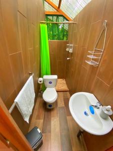 a bathroom with a toilet and a sink at Las Arrieras Nature Reserve and Ecolodge in Horquetas