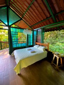 a bedroom with a bed in a tent at Las Arrieras Nature Reserve and Ecolodge in Horquetas