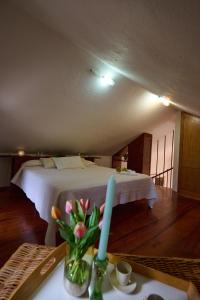 Un dormitorio con una cama y una mesa con una vela en Casa La Casamera, en Guarazoca
