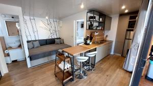 a kitchen with a table and a couch in a room at Mobile home 249 - Large Terrace & Private Jacuzzi in Selce