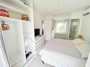 um quarto branco com uma cama e um frigorífico em Toquinho · Casa de Luxo c/ piscina em cond fechado - Toquinho em Ipojuca