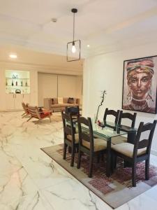 a living room with a dining table and chairs at Oasis in the City. Victoria Island serviced apt. in Lagos