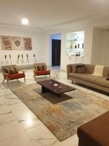 a living room with couches and a coffee table at Oasis in the City. Victoria Island serviced apt. in Lagos
