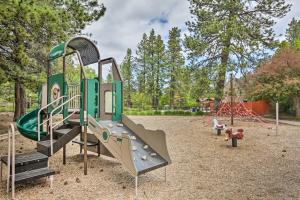 a playground with a slide in a park at Chic Bend Condo with Fireplace and Forest Views! in Bend