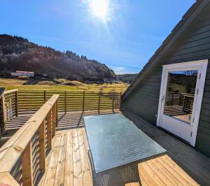a porch with a bench on the side of a building at Countryside experience in a Cozy Loft Near Bergen in Frekhaug