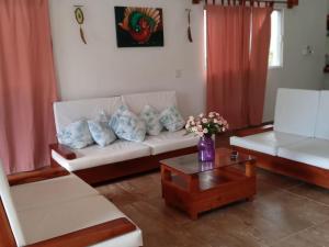 un soggiorno con un divano bianco e un tavolino da caffè di La Casa Naranja en Holbox a Isola Holbox