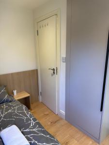 a bedroom with a white door and a bed at Not very quiet but best Location in London