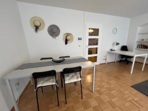 a room with a table and chairs and a desk at Waldshut -Kaiser55 in Waldshut-Tiengen