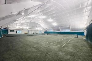 a tennis court in a building with a tennis racket at Villa Del Mar in Corolla