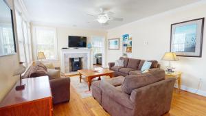 a living room with two couches and a fireplace at Family Time by Tybee Vacation Rentals in Tybee Island